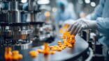 Pharmaceutical,Manufacturing,Line.,Workers,In,Protective,Gear,Handle,Pills,And